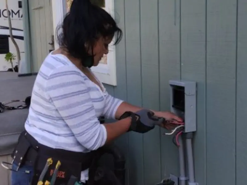 Licensed electrician wiring an exterior subpanel in San Bruno